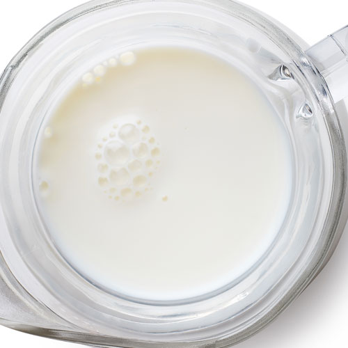 Pitcher filled with fresh milk, viewed from above